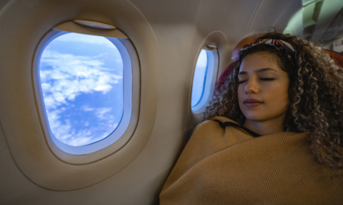 a girl sleeping in a flight